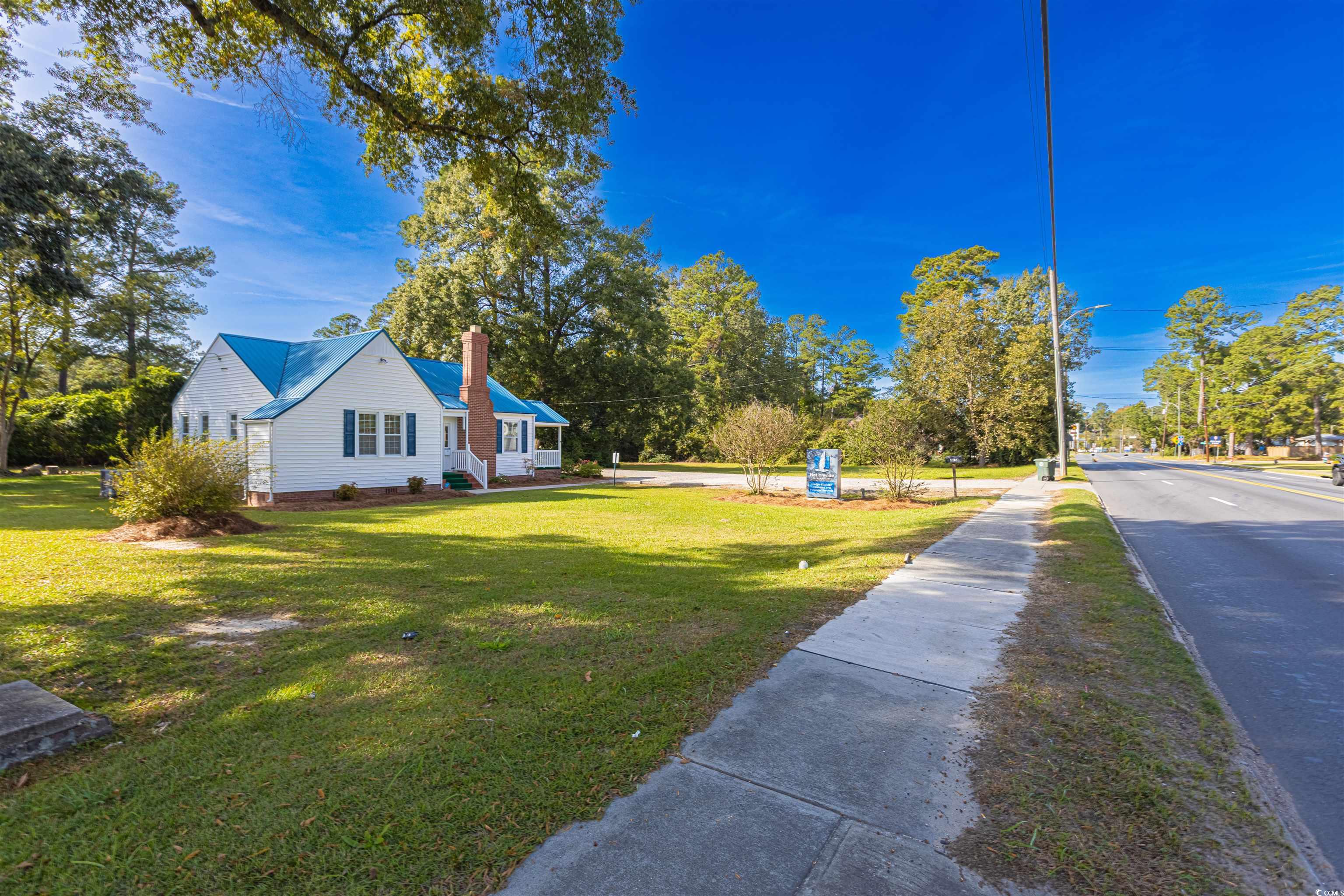 505 North Longstreet Street Kingstree, SC 29556 - Photo 24 of 34 View of side of property with a lawn and a chimney