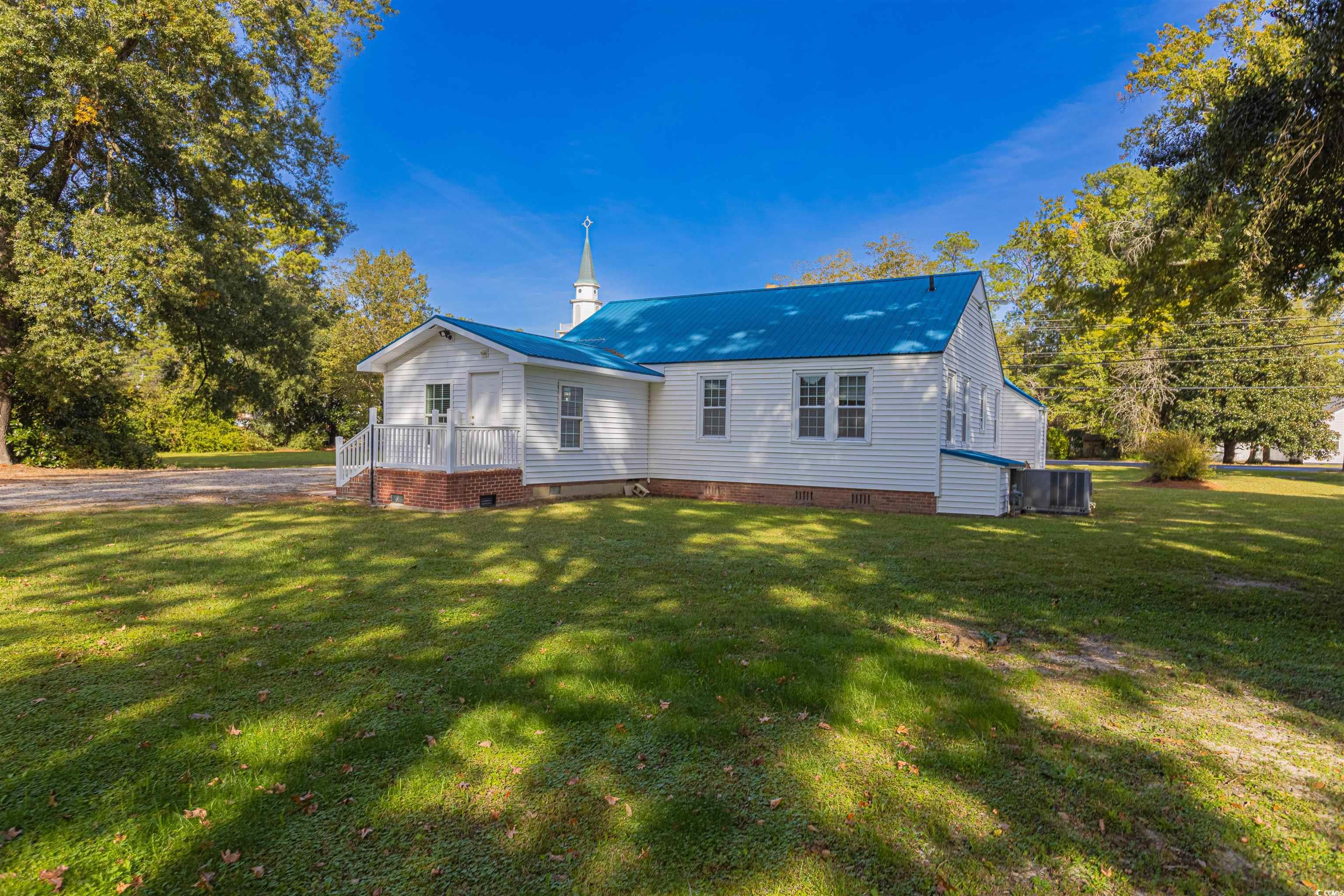 505 North Longstreet Street Kingstree, SC 29556 - Photo 31 of 34 Rear view of property with crawl space, a metal roof, a lawn, and a deck