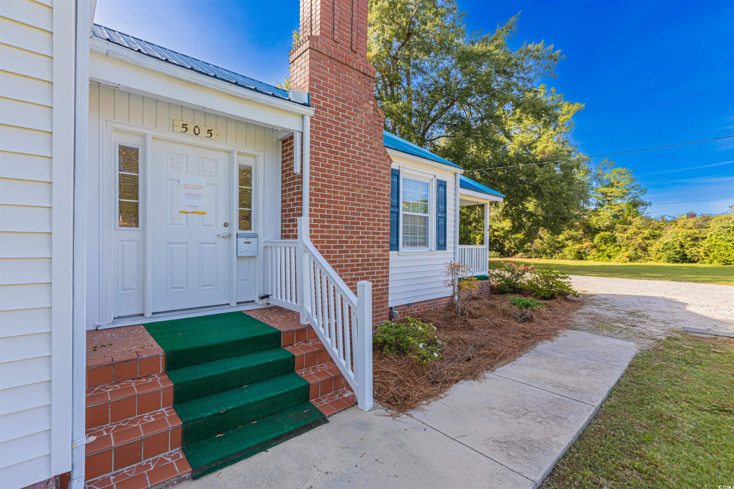 505 North Longstreet Street Kingstree, SC 29556 - Photo 4 of 34 Property entrance with a metal roof and a chimney