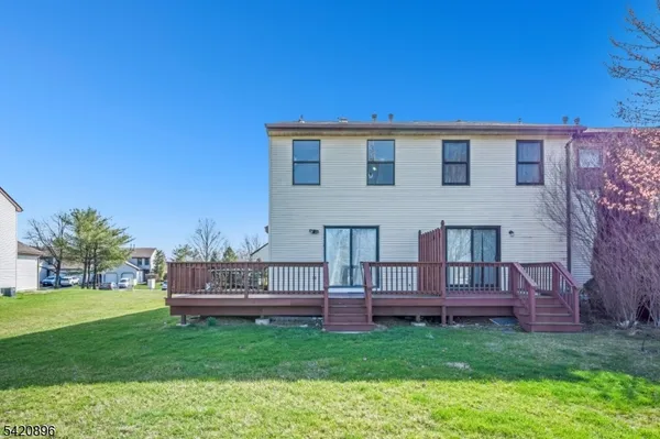 a view of backyard with barbeque grill and wooden fence