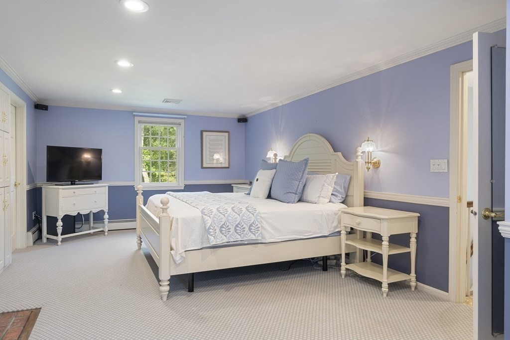 57 Surrey Lane Boxford, MA 01921 - Photo 27 of 42 a bedroom with a bed and a flat screen tv