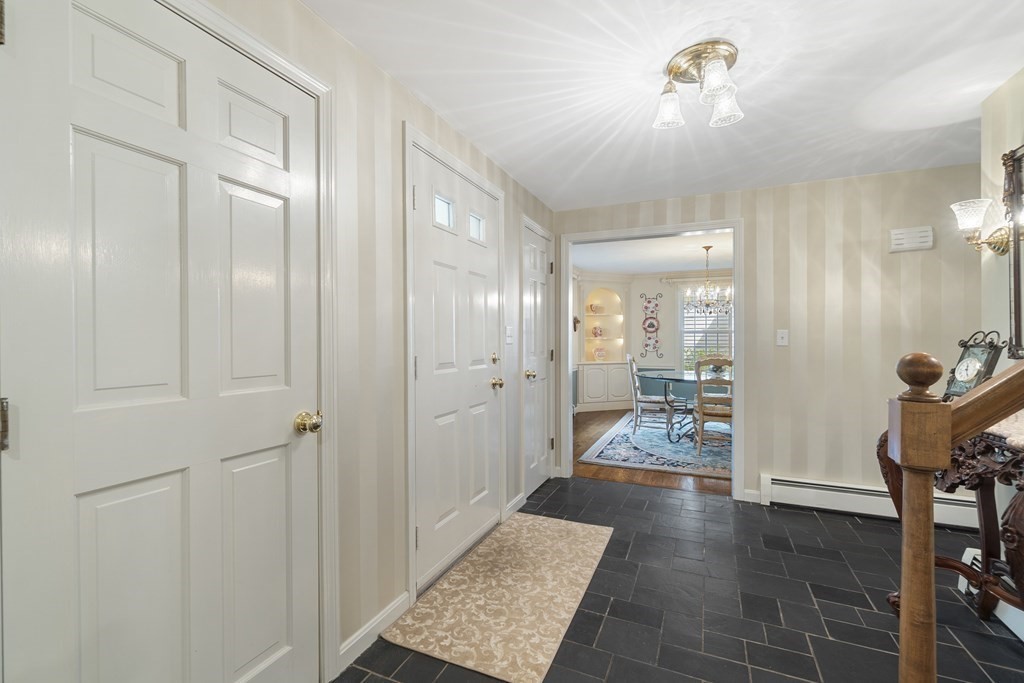 57 Surrey Lane Boxford, MA 01921 - Photo 6 of 42 a view of a hallway with wooden floor and a bathroom