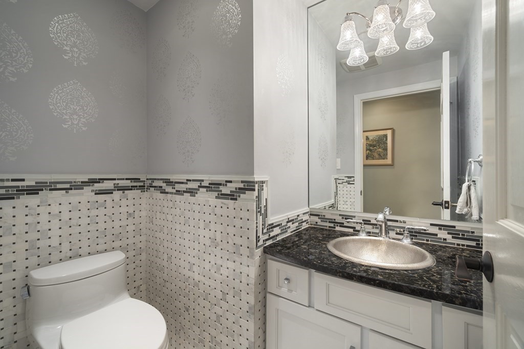 57 Surrey Lane Boxford, MA 01921 - Photo 8 of 42 a bathroom with a granite countertop toilet sink and mirror