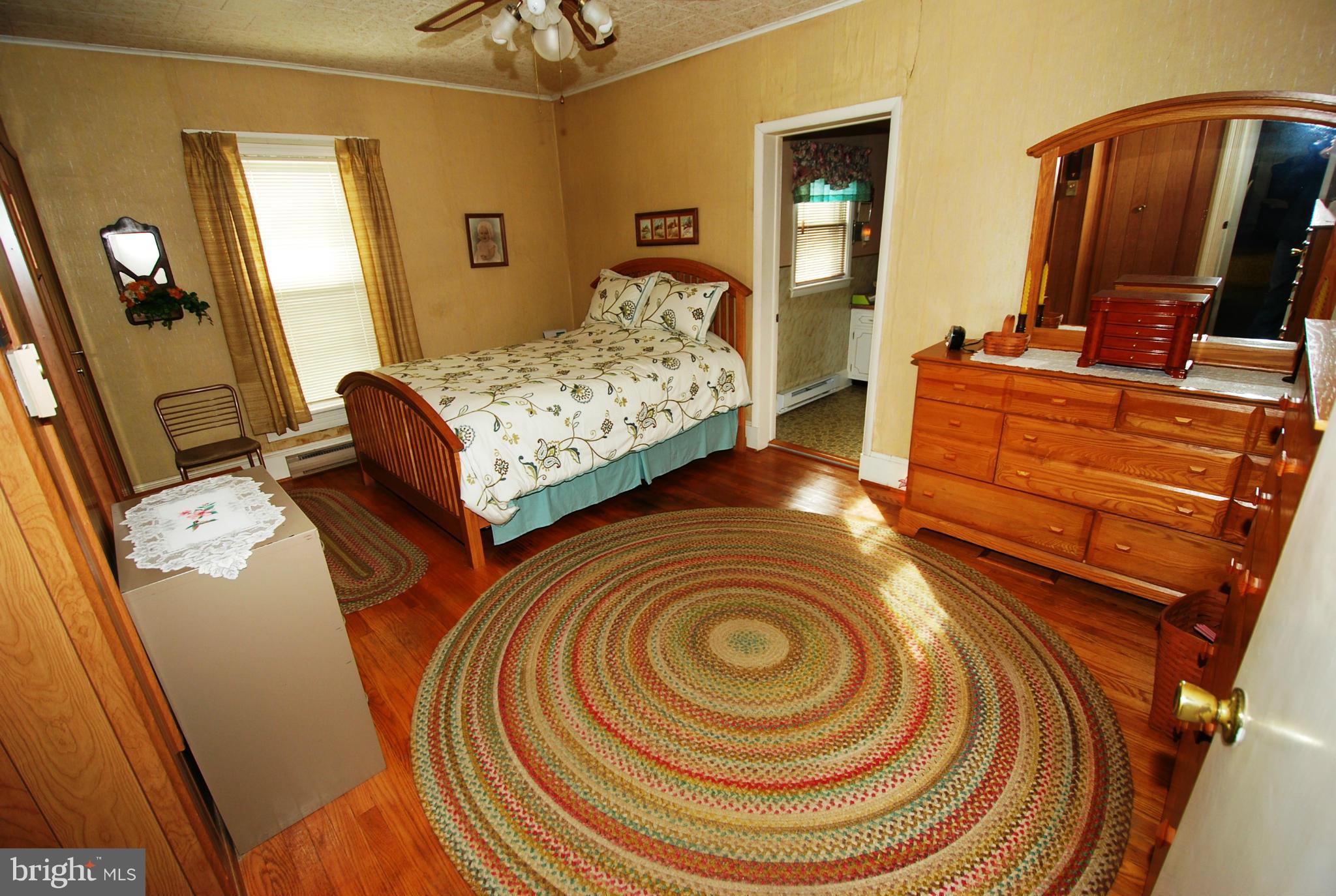 28055 Ridge Road Mount Airy, MD 21771 - Photo 16 of 30 a bedroom with bed and wooden floor