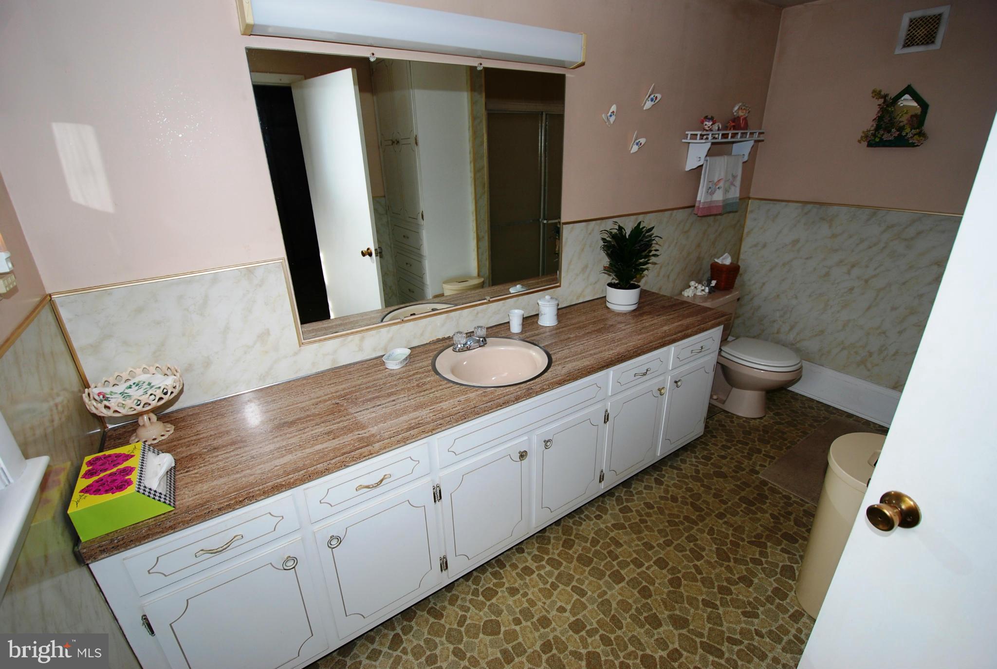 28055 Ridge Road Mount Airy, MD 21771 - Photo 17 of 30 a bathroom with a granite countertop sink and a mirror