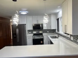 a kitchen with a refrigerator a sink and a stove