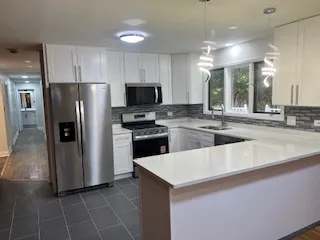 a kitchen with stainless steel appliances a refrigerator sink and microwave