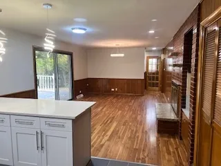 a view of kitchen with sink and refrigerator