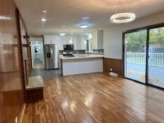 a large kitchen with kitchen island a sink stainless steel appliances and cabinets