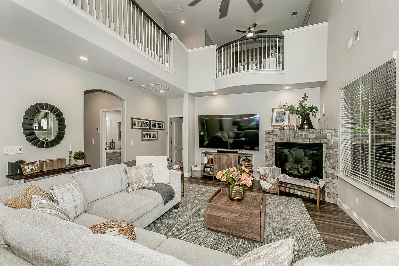 1175 Applegate Avenue Clovis, CA 93611 - Photo 11 of 65 a living room with furniture a fireplace and a floor to ceiling window