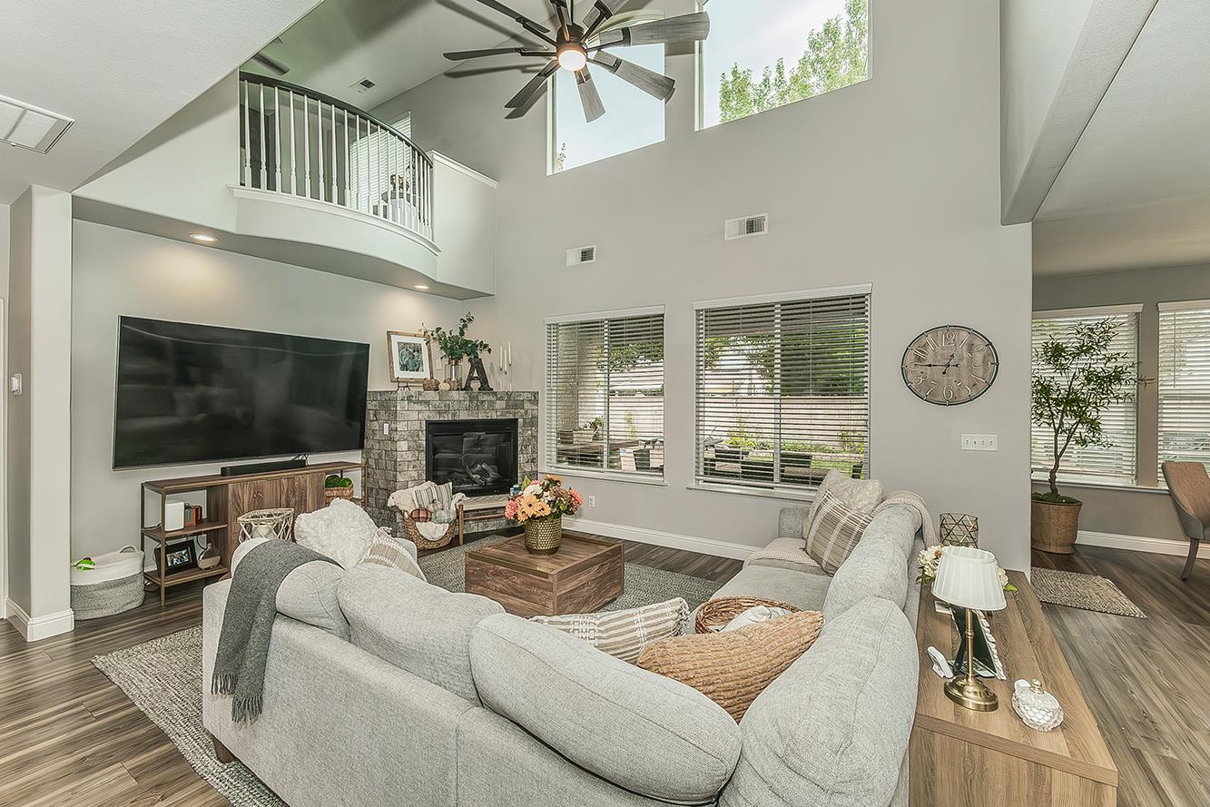 1175 Applegate Avenue Clovis, CA 93611 - Photo 12 of 65 a living room with furniture a fireplace and a flat screen tv