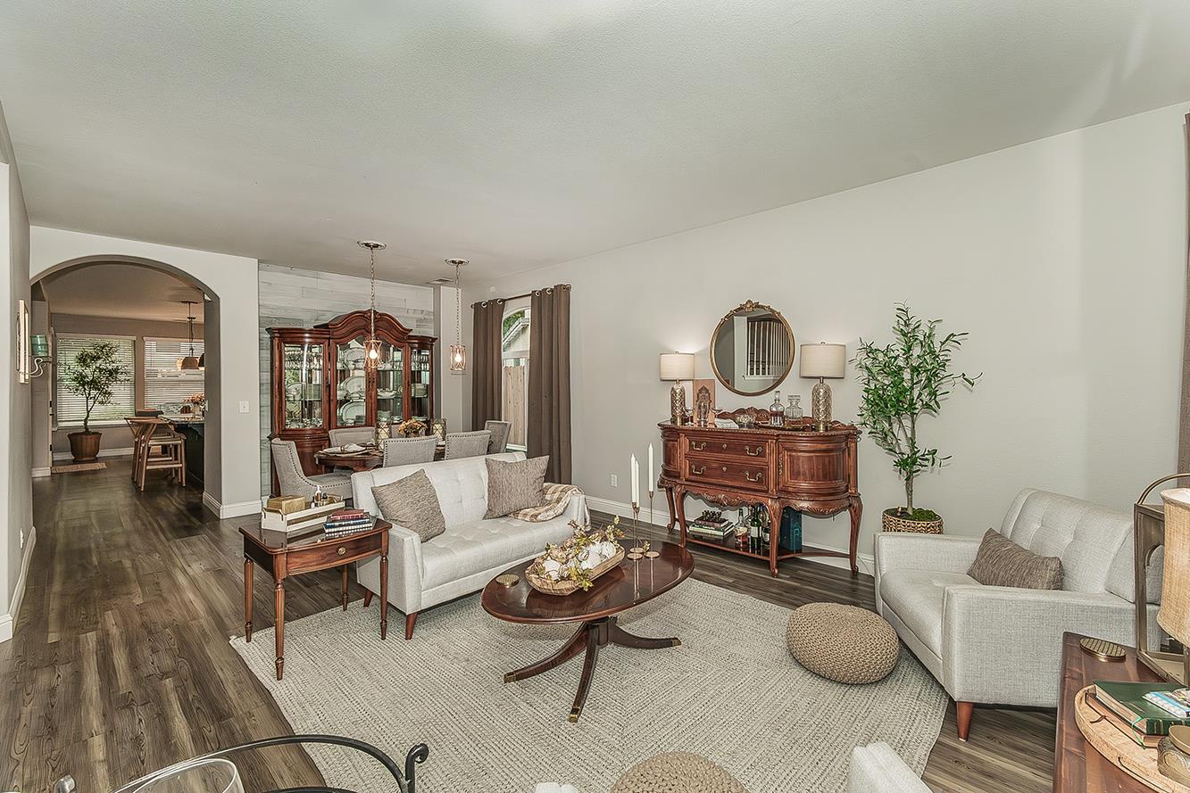 1175 Applegate Avenue Clovis, CA 93611 - Photo 16 of 65 a living room with furniture a rug and a chandelier