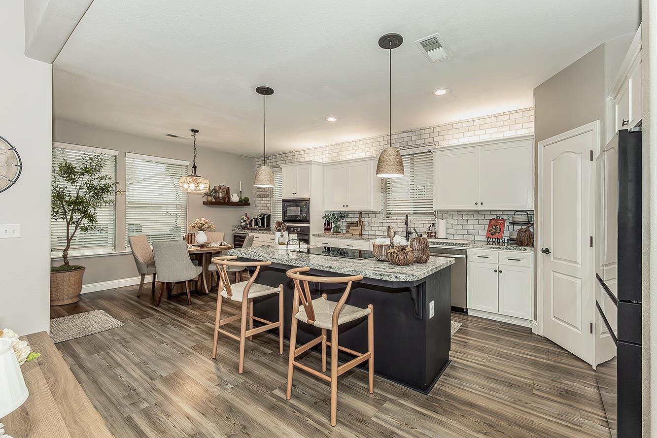 1175 Applegate Avenue Clovis, CA 93611 - Photo 2 of 65 a kitchen with stainless steel appliances a dining table chairs stove and sink