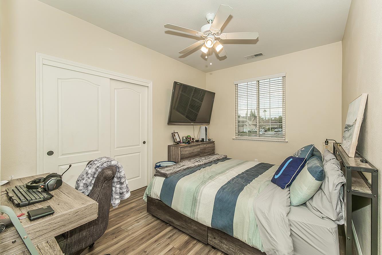 1175 Applegate Avenue Clovis, CA 93611 - Photo 29 of 65 a bedroom with bed and a flat screen tv