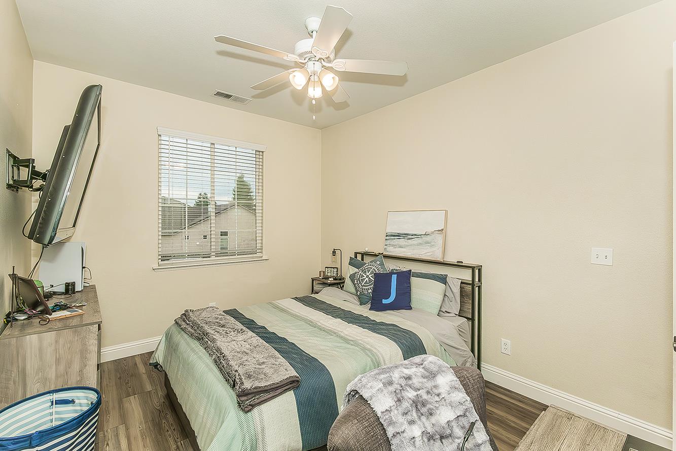 1175 Applegate Avenue Clovis, CA 93611 - Photo 30 of 65 a bedroom with a bed and a chandelier