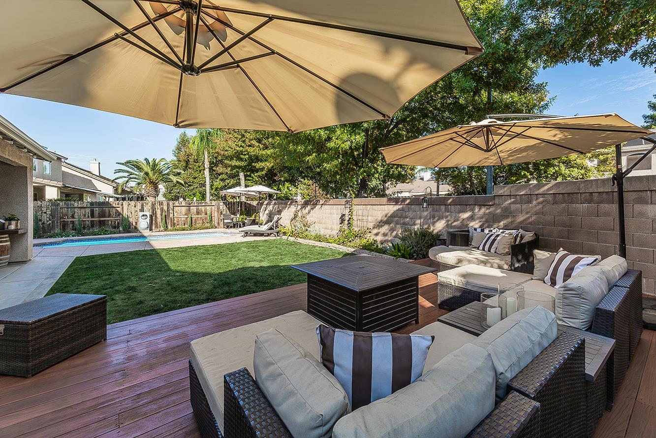 1175 Applegate Avenue Clovis, CA 93611 - Photo 44 of 65 a view of a patio with couches under an umbrella