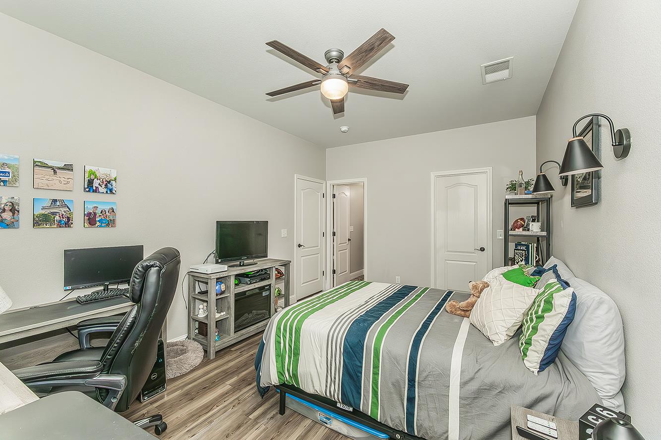 1175 Applegate Avenue Clovis, CA 93611 - Photo 50 of 65 a bedroom with a bed and a flat screen tv