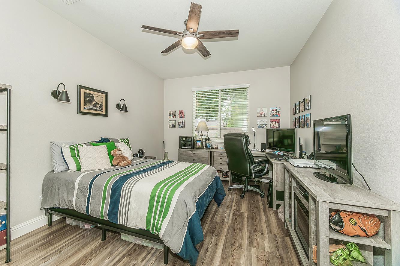 1175 Applegate Avenue Clovis, CA 93611 - Photo 51 of 65 a bedroom with a bed and a flat screen tv