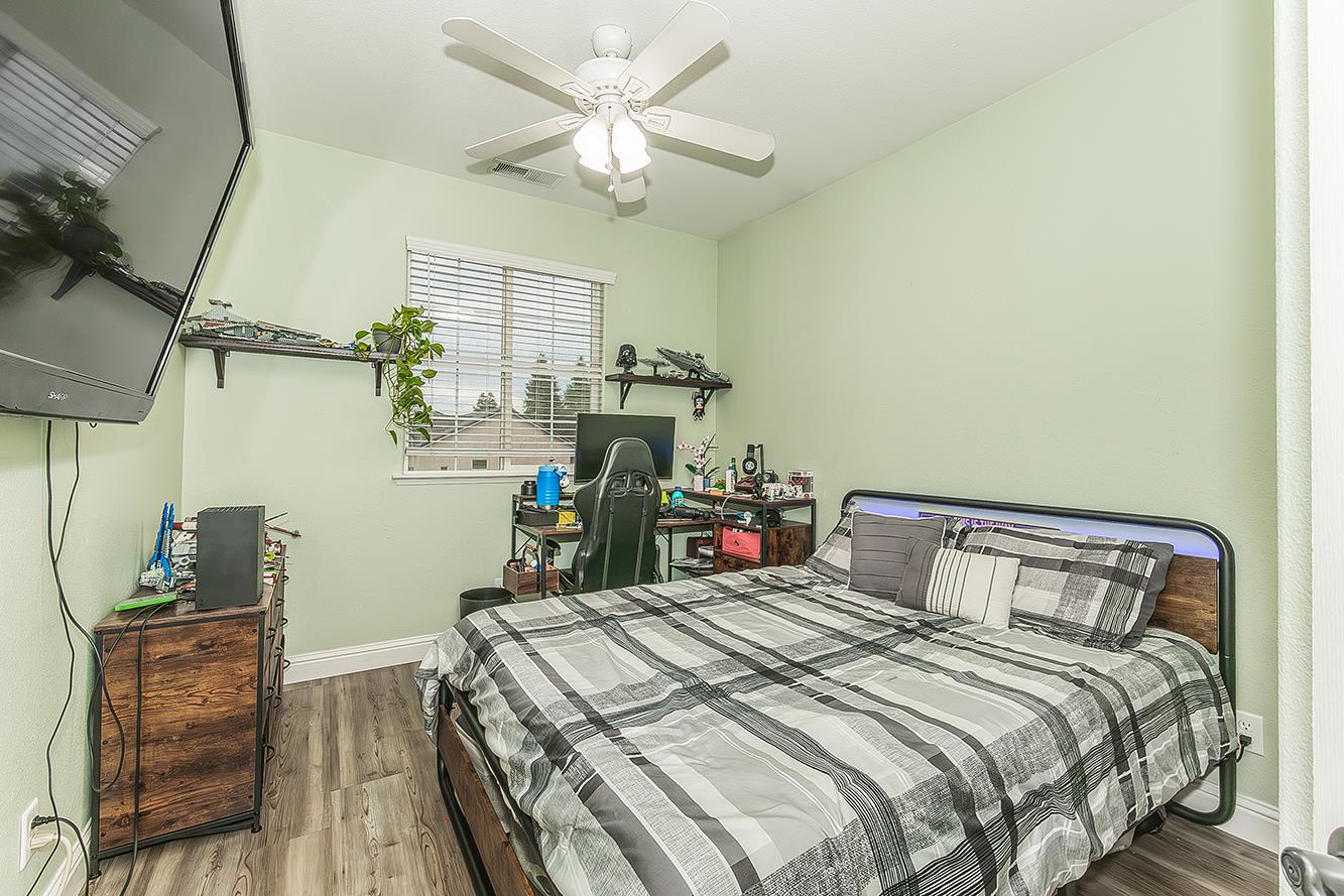 1175 Applegate Avenue Clovis, CA 93611 - Photo 53 of 65 a bedroom with a bed and a chandelier