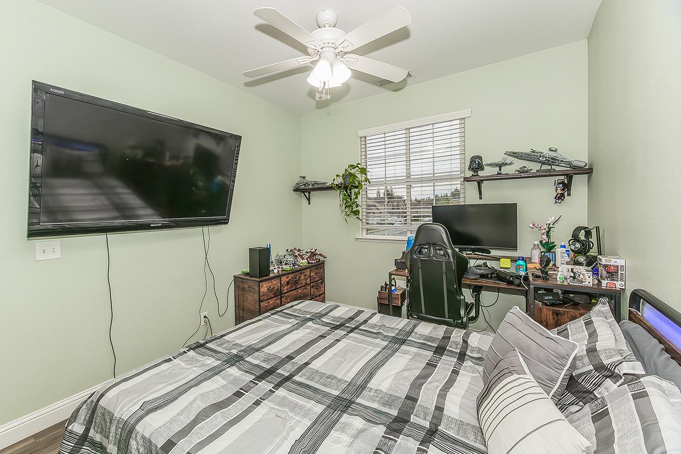 1175 Applegate Avenue Clovis, CA 93611 - Photo 54 of 65 a bedroom with a bed and a flat screen tv