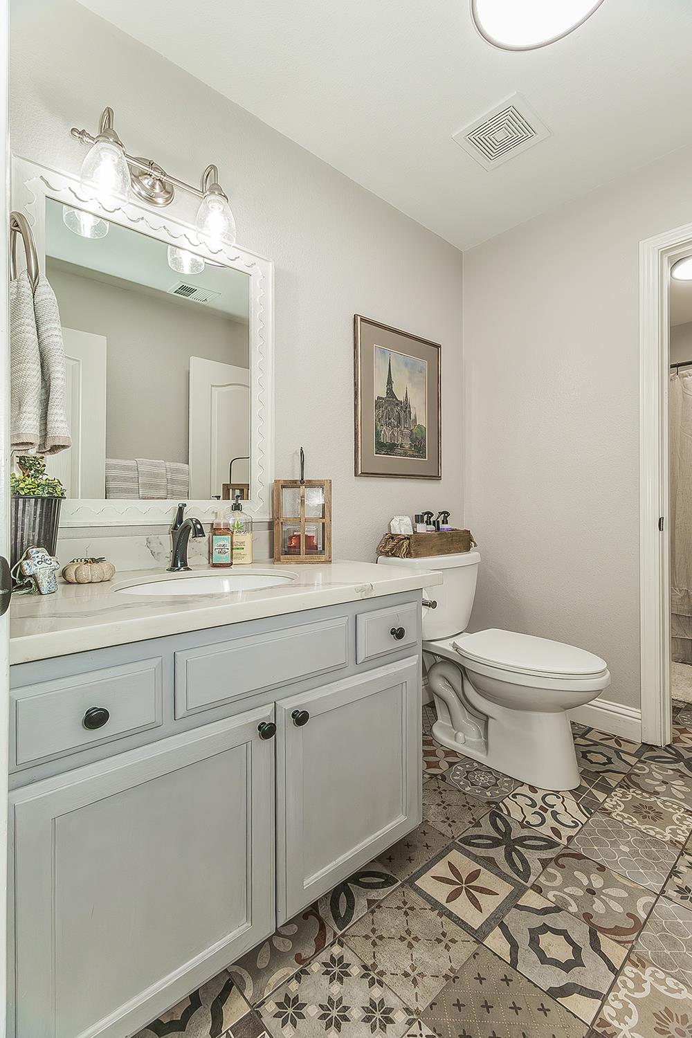 1175 Applegate Avenue Clovis, CA 93611 - Photo 55 of 65 a bathroom with a toilet a sink and mirror