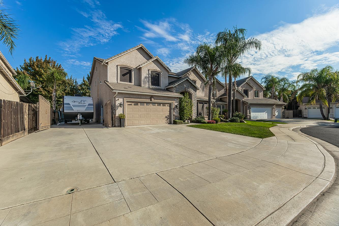 1175 Applegate Avenue Clovis, CA 93611 - Photo 59 of 65 a front view of a house with a yard and garage