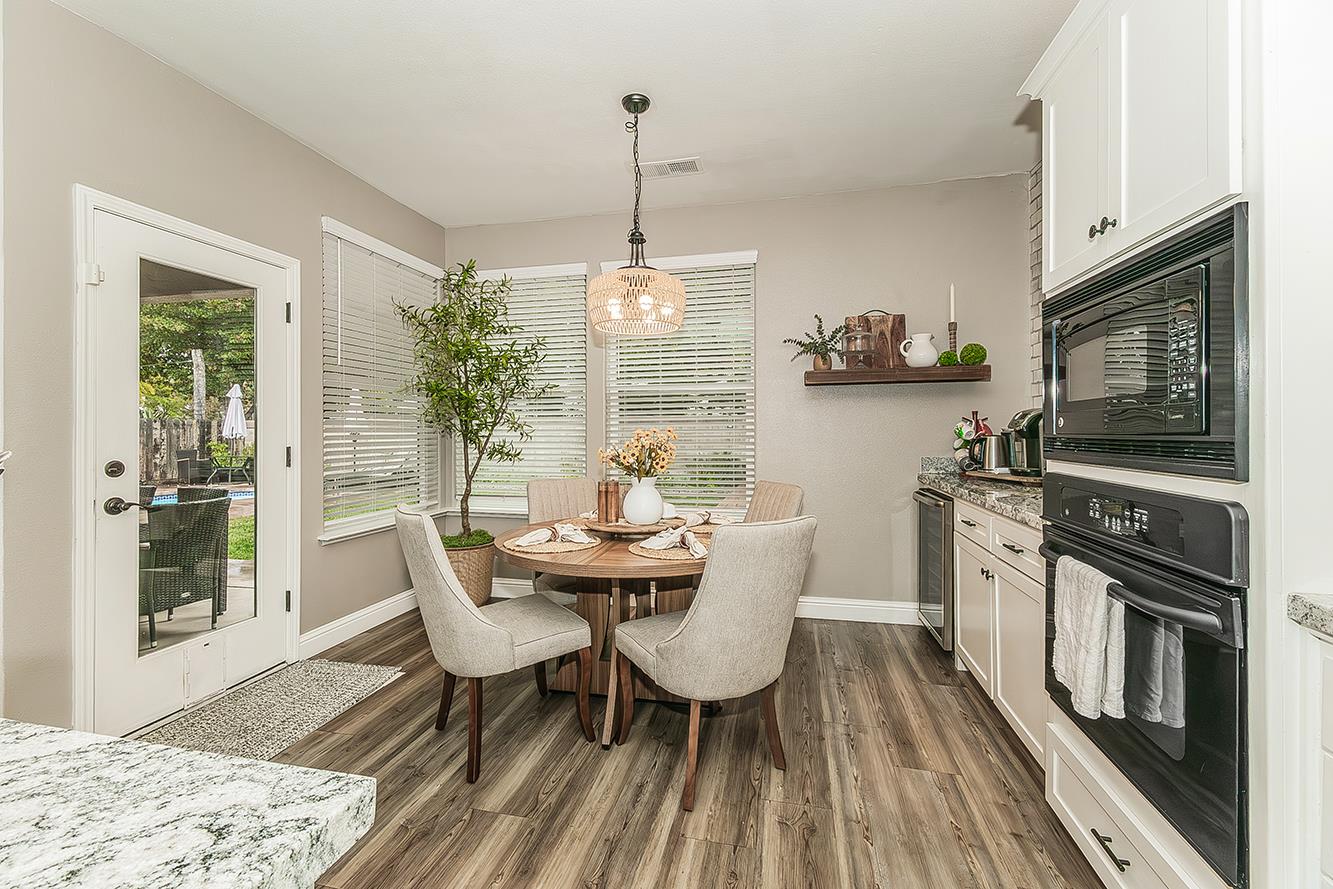 1175 Applegate Avenue Clovis, CA 93611 - Photo 6 of 65 a dining room with furniture a window and wooden floor