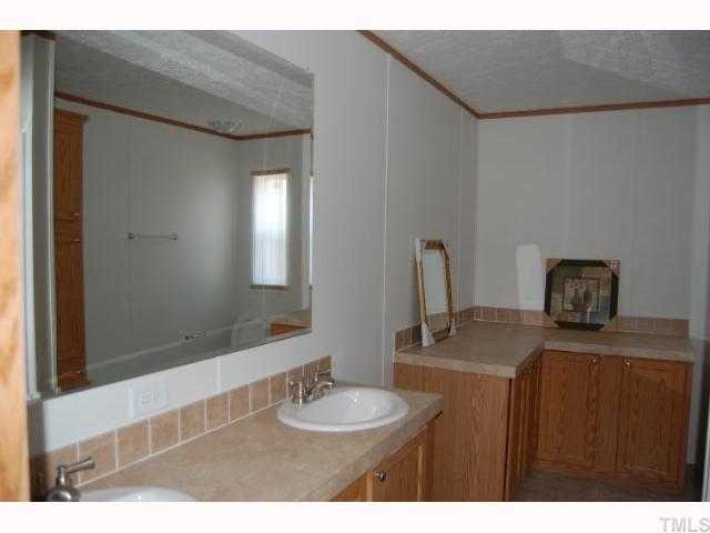 3514 Walters Road Creedmoor, NC 27522 - Photo 8 of 9 a bathroom with a sink and a mirror