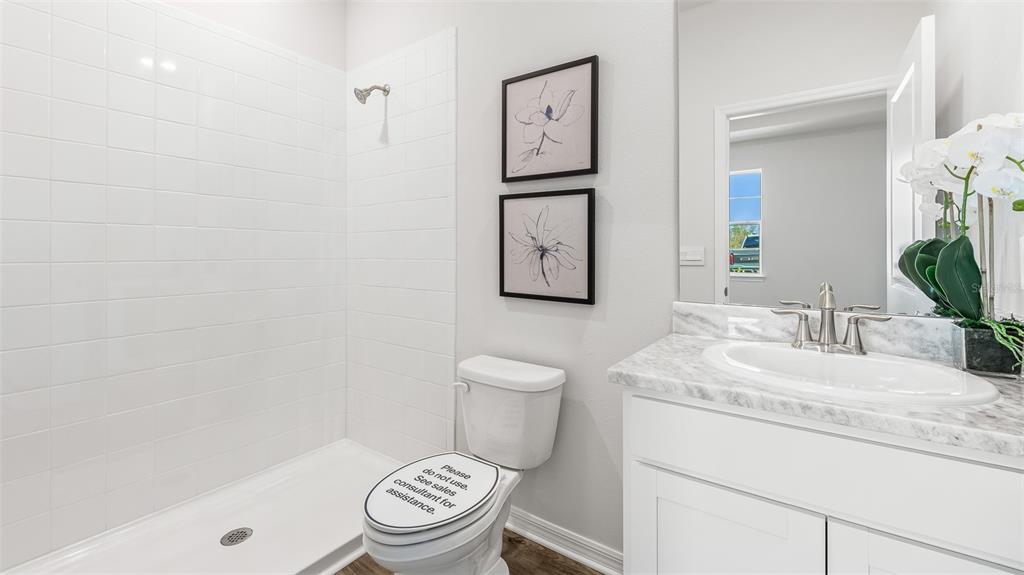 17932 Gander Terrace Lakewood Ranch, FL 34211 - Photo 14 of 52 a bathroom with a granite countertop toilet sink and mirror