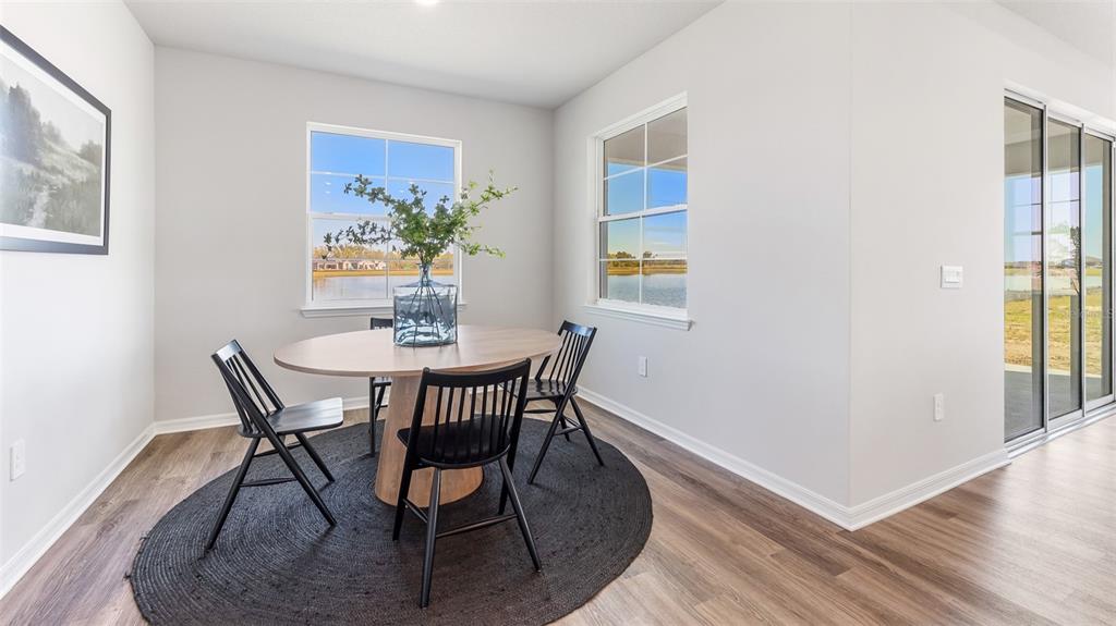 17932 Gander Terrace Lakewood Ranch, FL 34211 - Photo 16 of 52 a view of a dining room with furniture and wooden floor