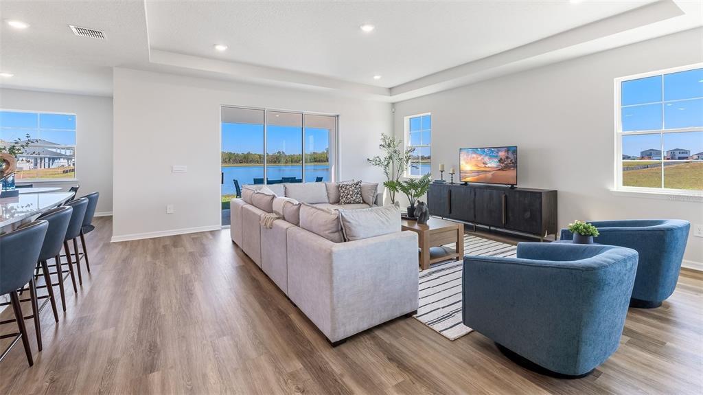 17932 Gander Terrace Lakewood Ranch, FL 34211 - Photo 2 of 52 a living room with furniture and a flat screen tv