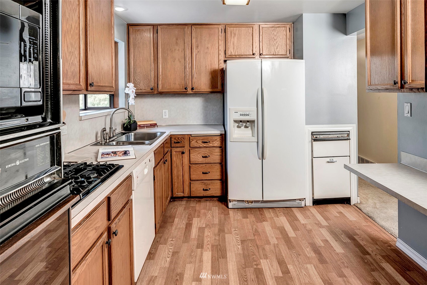 2322 243rd Place Southwest Bothell, WA 98021 - Photo 8 of 29 a kitchen with stainless steel appliances a refrigerator stove and sink