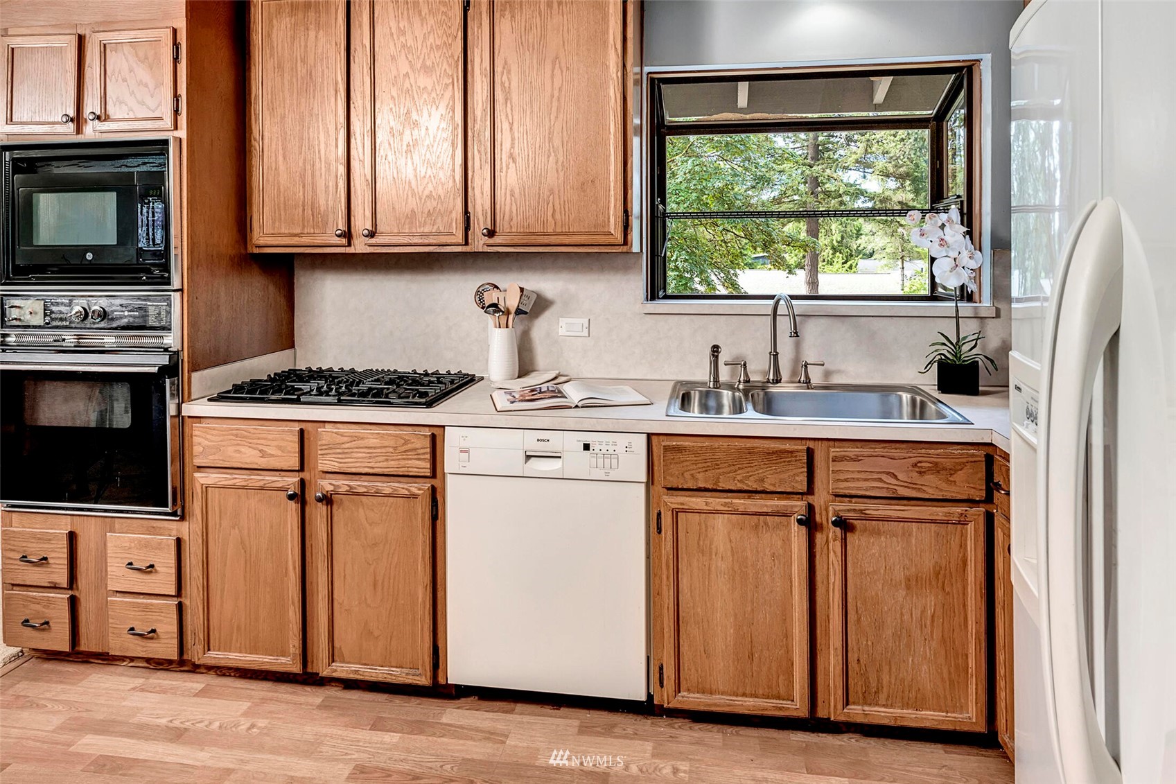 2322 243rd Place Southwest Bothell, WA 98021 - Photo 9 of 29 a kitchen with appliances a sink and a window