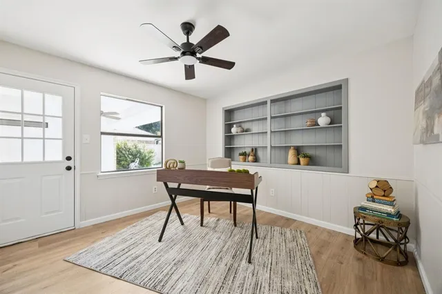 a workspace with wooden floor and a window