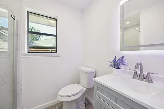 a bathroom with a sink toilet and a mirror