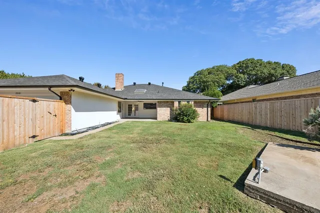 a wooden bench sitting in front of house
