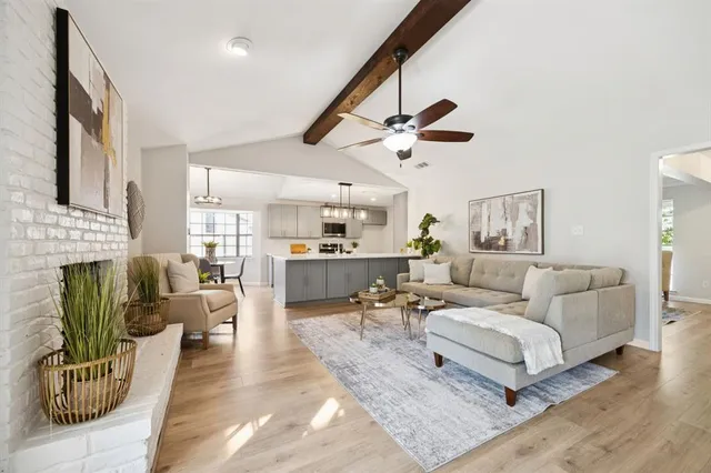 a living room with furniture wooden floor and a fireplace