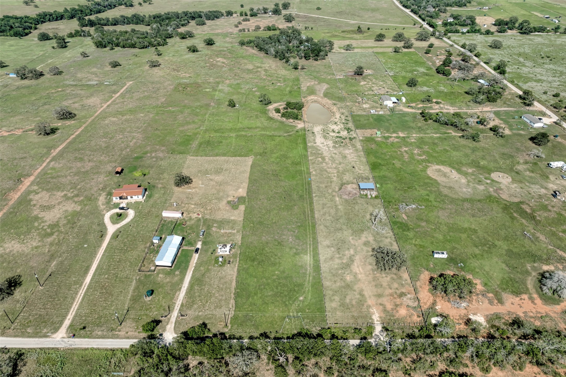 5309 Tenney Creek Road Luling, TX 78648 - Photo 11 of 23 Sprawling acreage offers a pond, numerous outbuildings, and ample space for rural living.