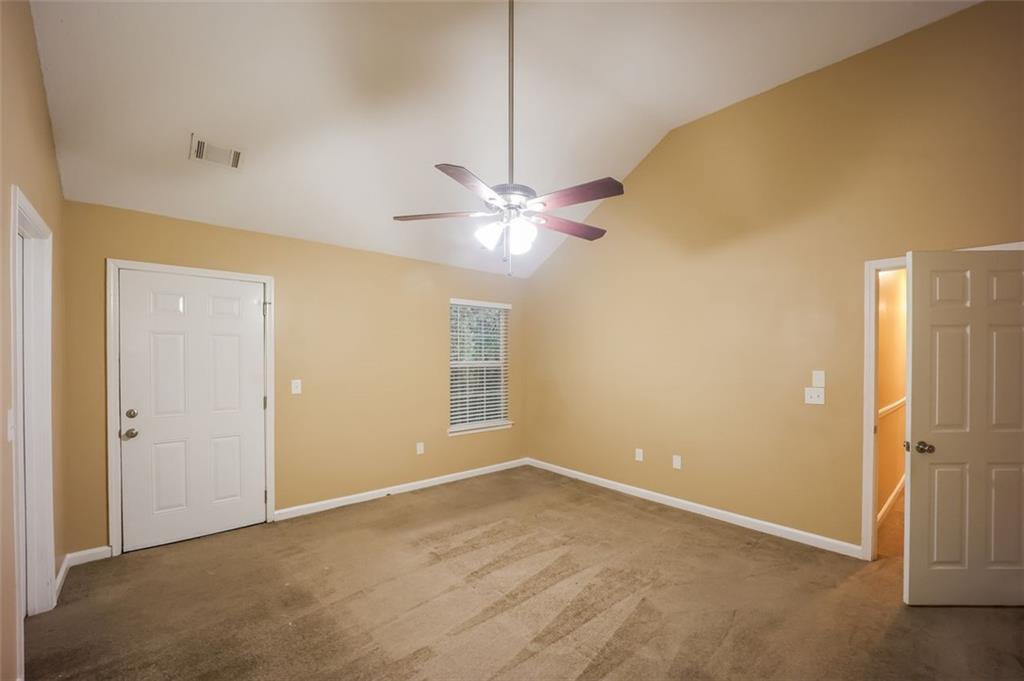 4827 Wolfcreek View Atlanta, GA 30349 - Photo 3 of 7 an empty room with closet and a chandelier fan