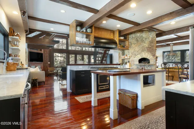a view of a dining room with furniture a rug and wooden floor