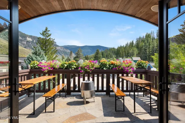 a view of a patio with table and chairs