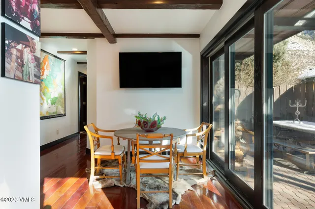 a living room with furniture and a large wooden floor
