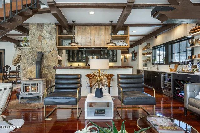 a living room with stainless steel appliances kitchen island granite countertop furniture wooden floor and a kitchen view