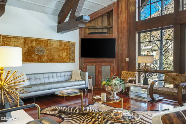 a room with stainless steel appliances kitchen island granite countertop a sink and cabinets