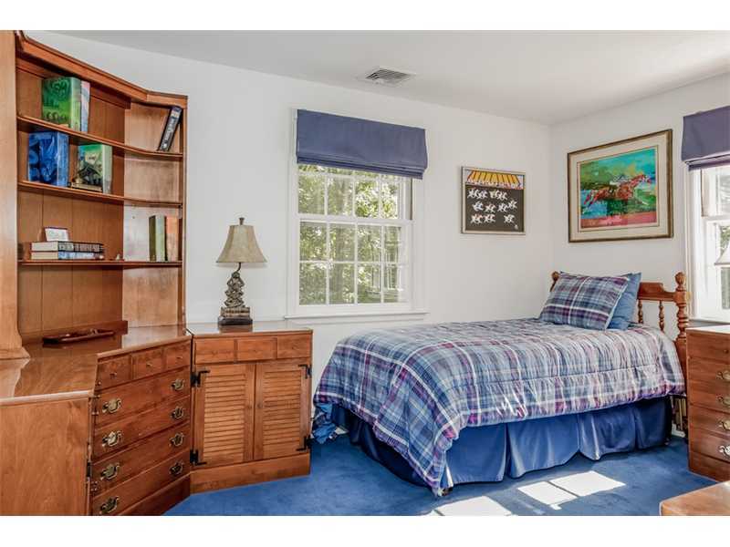 6 Windsor Road Darien, CT 06820 - Photo 16 of 25 a bedroom with a bed window and book shelf
