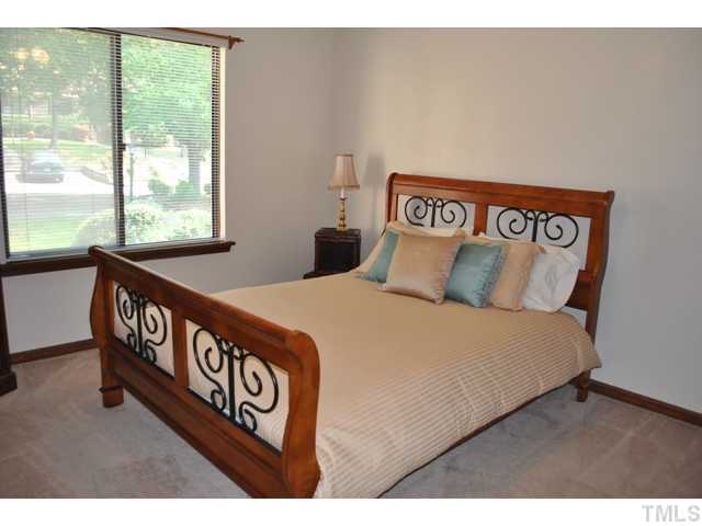 5843 Branchwood Road Raleigh, NC 27609 - Photo 15 of 25 a bedroom with a bed and a window
