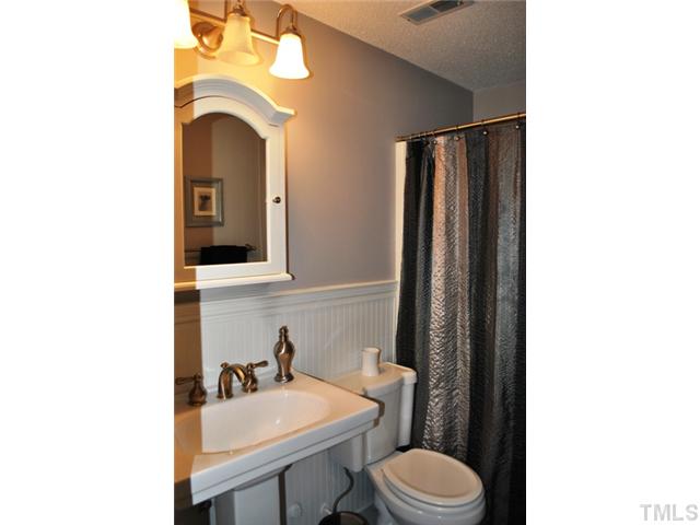 5843 Branchwood Road Raleigh, NC 27609 - Photo 22 of 25 a bathroom with a sink toilet and mirror