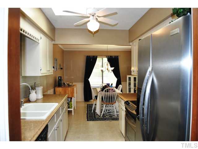 5843 Branchwood Road Raleigh, NC 27609 - Photo 5 of 25 a living room with furniture a window and appliances