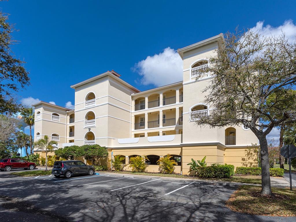 980 Cooper Street, Unit 302 Venice, FL 34285 - Photo 1 of 1 a front view of a building with street