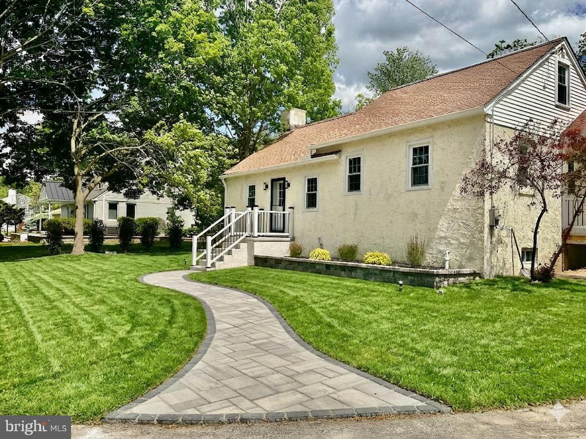 a view of a white house with a yard